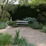 Beth Chatto Bench in gravel garden at Beth Chatto Gardens